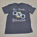A black short-sleeve t-shirt laid flat on a neutral gray background. The shirt features a graphic print with the gothic text 'Time, Laugh, Liberated' surrounding a graphic of handcuffs with a yellow and orange starburst explosion in the center.